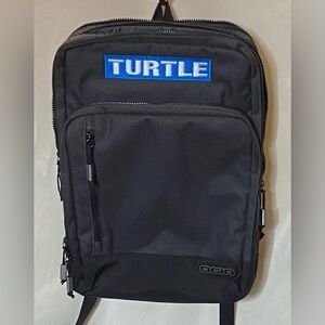 OGIO Sly 15" Laptop Backpack in gray/black with a custom "TURTLE" patch